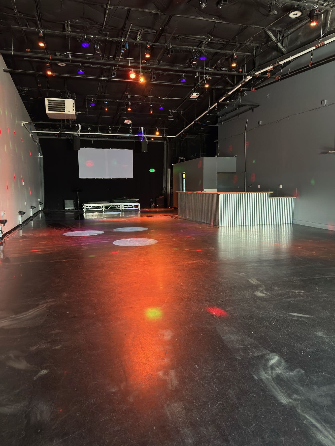 The Studio (NoBo) event floor looking toward the stage and screen