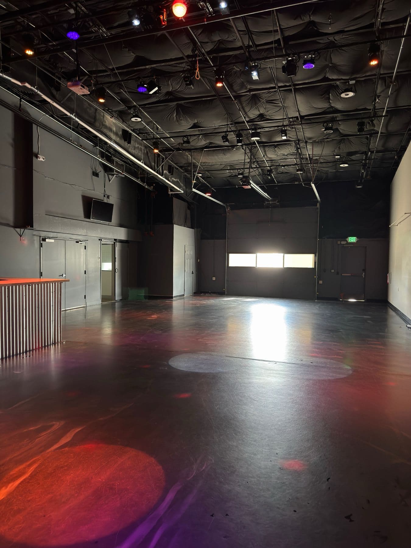 The Studio (NoBo) event space with daylight from the roll-up garage door